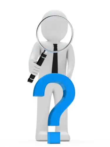 Bridging loans UK FAQ concept showing magnifying glass and question mark for common finance questions