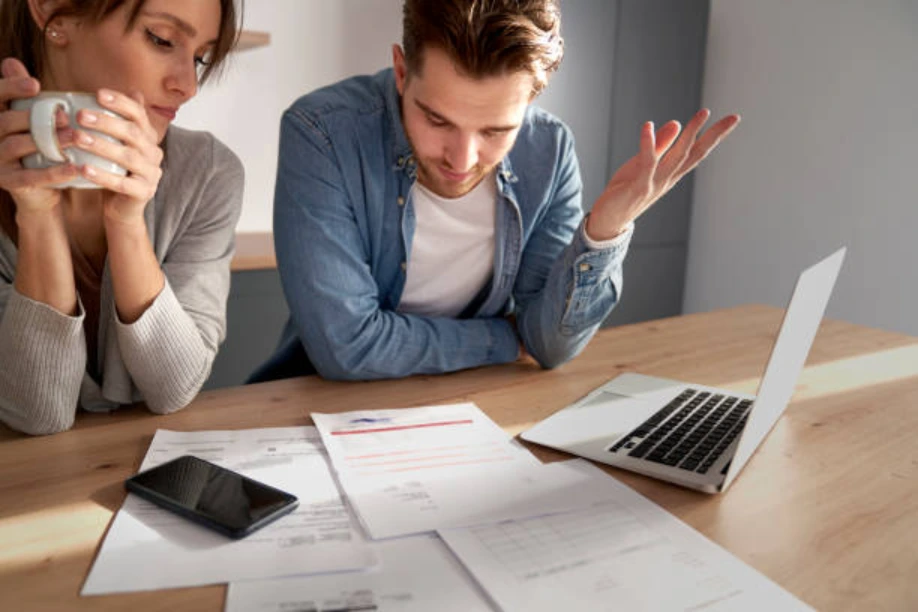 Business owners reviewing loan stress testing figures and mortgage documents