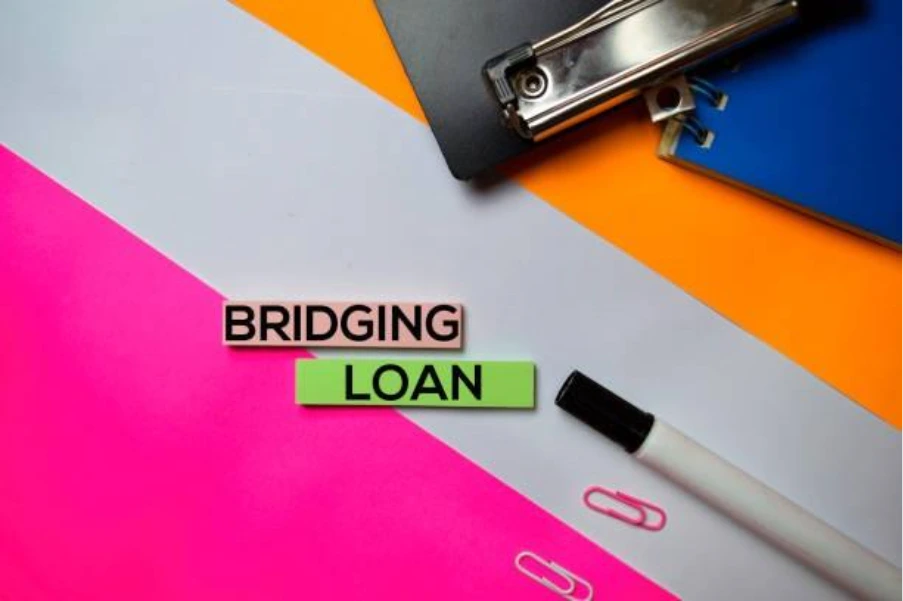 Bridging loan concept image with office stationery illustrating short term property finance for chain break transactions in the UK