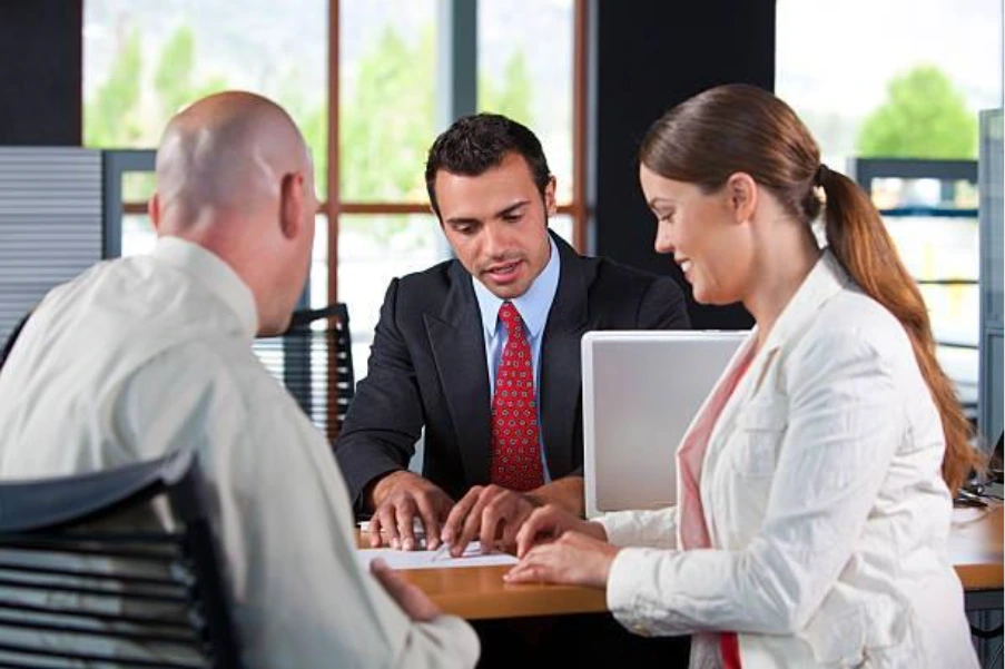 Property finance advisor discussing bridging loan options with clients during a meeting