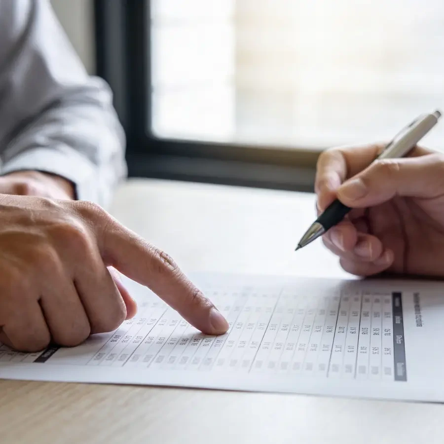 Reviewing Ltd company commercial mortgage financial figures Two professionals reviewing financial figures on a document with pen at desk